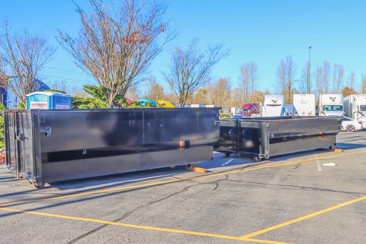 Professional dumpster rental service with roll-off container on residential driveway in Turner